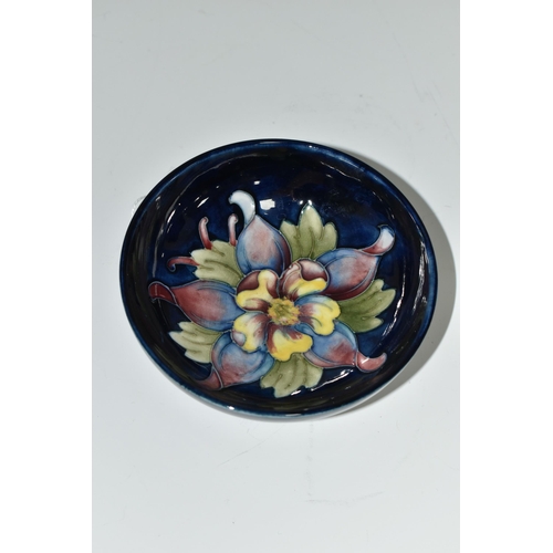 395 - A MOORCROFT POTTERY SMALL FOOTED BOWL, decorated with Columbine on a blue ground, impressed and pain... 