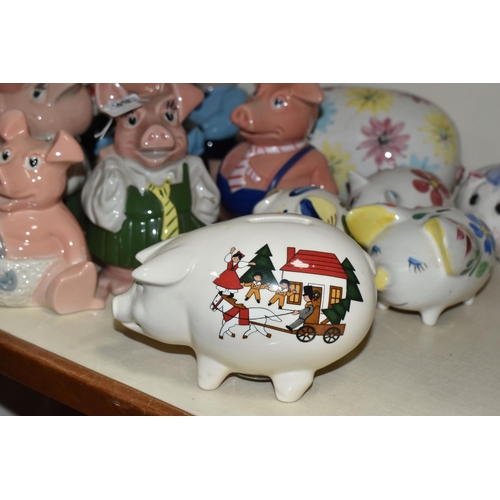 397 - NINE WADE NATWEST PIG MONEY BOXES AND EIGHT OTHER CERAMIC PIGGY BANKS, the NatWest comprising two Wo... 