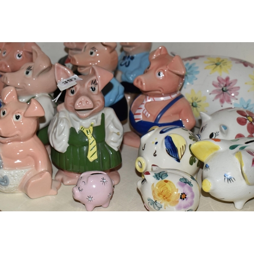 397 - NINE WADE NATWEST PIG MONEY BOXES AND EIGHT OTHER CERAMIC PIGGY BANKS, the NatWest comprising two Wo... 