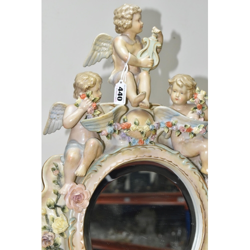 440 - AN EARLY 20TH CENTURY SITZENDORF PORCELAIN FLORAL ENCRUSTED AND FIGURAL MIRROR, modelled with three ... 