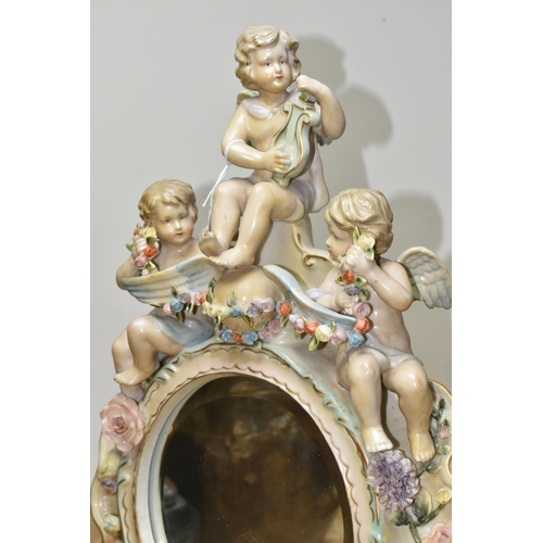 440 - AN EARLY 20TH CENTURY SITZENDORF PORCELAIN FLORAL ENCRUSTED AND FIGURAL MIRROR, modelled with three ... 