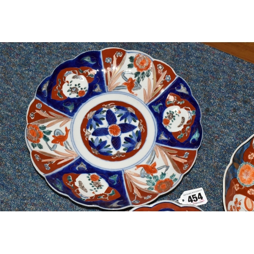 454 - THREE LATE 19TH CENTURY JAPANESE IMARI PLATES, all with wavy rims, varying designs with flora and fi... 