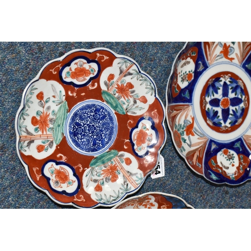 454 - THREE LATE 19TH CENTURY JAPANESE IMARI PLATES, all with wavy rims, varying designs with flora and fi... 