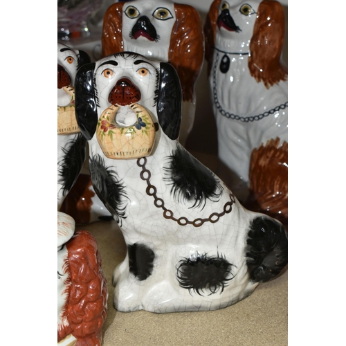 460 - A PAIR OF LATE 19TH / EARLY 20TH CENTURY STAFFORDSHIRE POTTERY SEATED SPANIELS, height 27cm approx.,... 