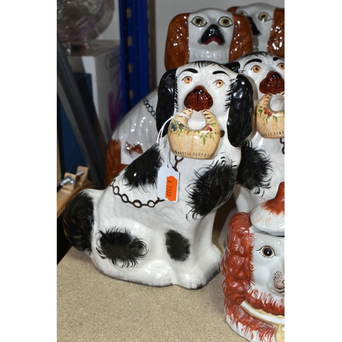 460 - A PAIR OF LATE 19TH / EARLY 20TH CENTURY STAFFORDSHIRE POTTERY SEATED SPANIELS, height 27cm approx.,... 