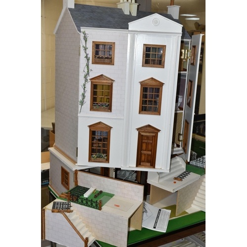 510 - A MODERN FOUR STOREY DOLLS HOUSE OF GEORGIAN STYLE WITH A QUANTITY OF ACCESSORIES, the top three sto... 