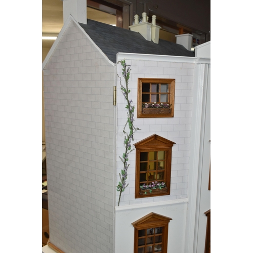 510 - A MODERN FOUR STOREY DOLLS HOUSE OF GEORGIAN STYLE WITH A QUANTITY OF ACCESSORIES, the top three sto... 