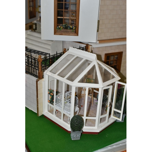 510 - A MODERN FOUR STOREY DOLLS HOUSE OF GEORGIAN STYLE WITH A QUANTITY OF ACCESSORIES, the top three sto... 