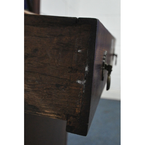 1213 - A 20TH CENTURY OAK CABINET, the single glazed door enclosing three adjustable shelves, above a singl... 