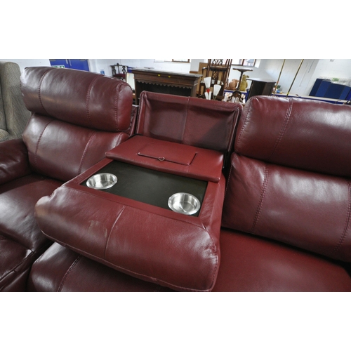 1306 - A RED LEATHER ELECTRIC THREE SEATER SOFA, with multiple buttons to recline, adjustable headrest, cen... 