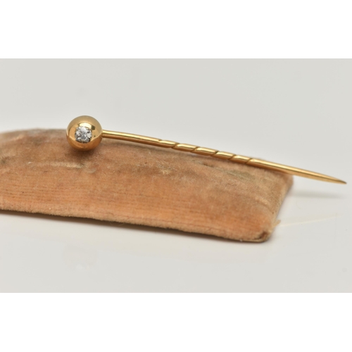 10 - A YELLOW METAL, OLD CUT DIAMOND STICK PIN, polished dome set with an old cut diamond, rub over setti... 