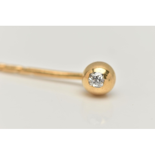 10 - A YELLOW METAL, OLD CUT DIAMOND STICK PIN, polished dome set with an old cut diamond, rub over setti... 