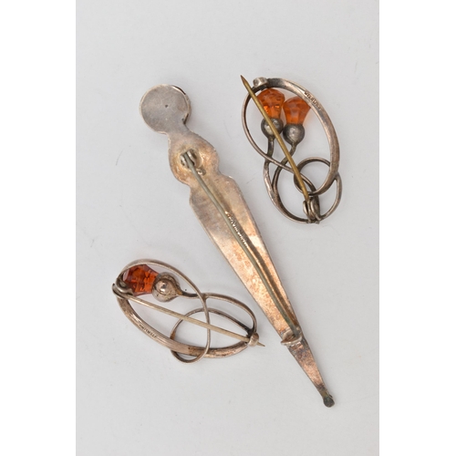 14 - THREE BROOCHES, two white metal open work brooches of thistles set with faceted orange paste, both f... 