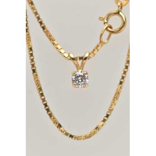 35 - A DIAMOND SINGLE STONE PENDANT WITH YELLOW METAL CHAIN, the pendant set with a round brilliant cut d... 