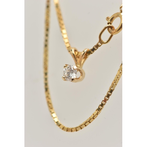 35 - A DIAMOND SINGLE STONE PENDANT WITH YELLOW METAL CHAIN, the pendant set with a round brilliant cut d... 