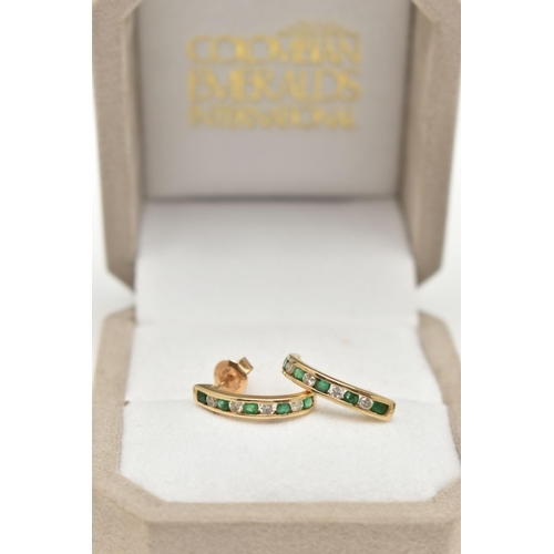 56 - A PAIR OF EMERALD AND DIAMOND EARRINGS, each designed as half hoops channel set with four brilliant ... 