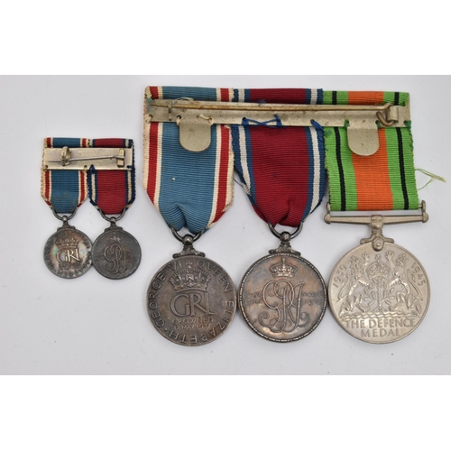 84 - THREE MEDALS AND TWO MINIATURE MEDALS, to include a WWII defense medal, and two 'George V and Queen ... 