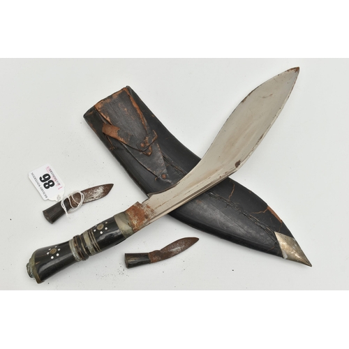 86 - A KUKRI KNIFE, with a horn handle in a leather sheaf with two additional inset knives, approximate l... 