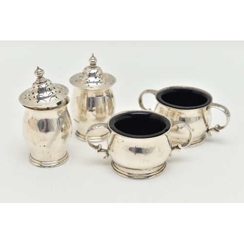 95 - AN IRISH SILVER CONDIMENT SET, the double handled salts with blue glass liners, and two matching pep... 