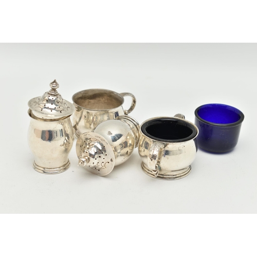 95 - AN IRISH SILVER CONDIMENT SET, the double handled salts with blue glass liners, and two matching pep... 