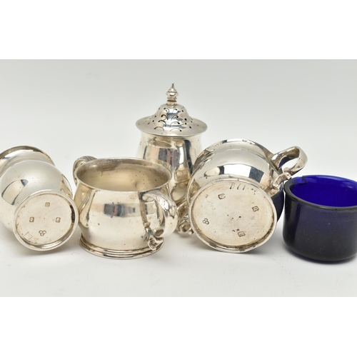 95 - AN IRISH SILVER CONDIMENT SET, the double handled salts with blue glass liners, and two matching pep... 