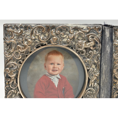 97 - A DOUBLE PHOTO FRAME, white metal lined frame, with  embossed foliate pattern with cherubs, folding ... 
