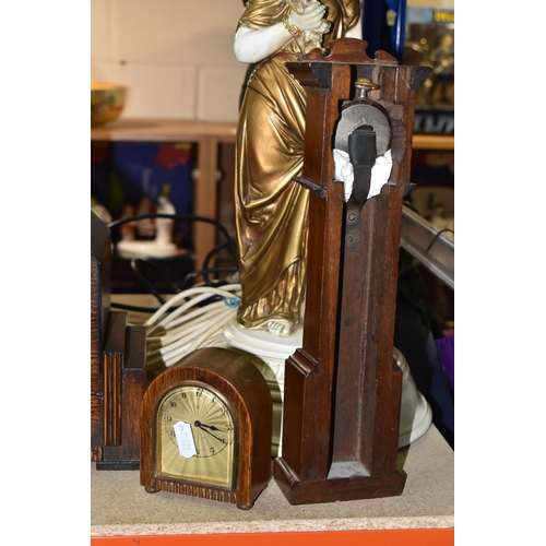 420 - A GROUP OF CLOCKS AND FIGURAL LAMP BASES, comprising a pocket watch and stand, the continental pocke... 