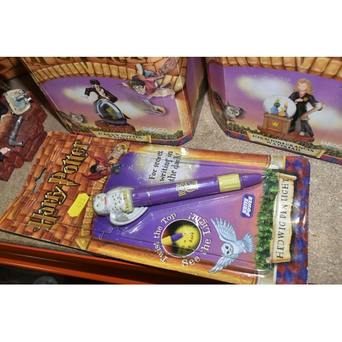 423 - A GROUP OF HARRY POTTER RELATED ITEMS, to include four boxed Enesco 'water balls': Harry Potter, Her... 