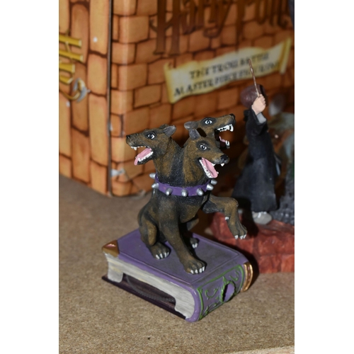 423 - A GROUP OF HARRY POTTER RELATED ITEMS, to include four boxed Enesco 'water balls': Harry Potter, Her... 