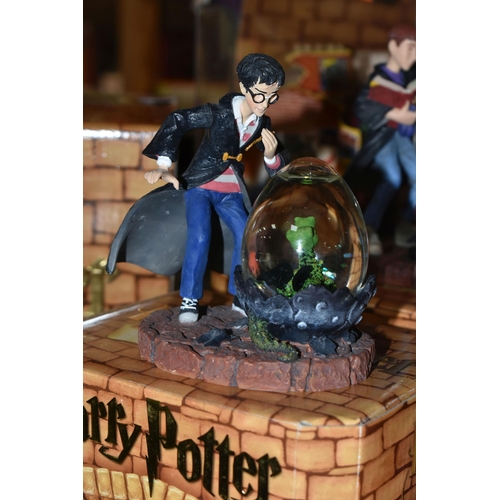 423 - A GROUP OF HARRY POTTER RELATED ITEMS, to include four boxed Enesco 'water balls': Harry Potter, Her... 