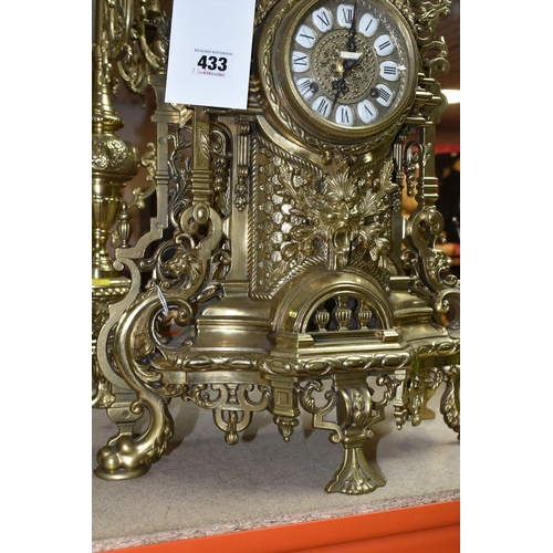 433 - A BRASS FRANZ HERMLE CLOCK GARNITURE, the clock having a chapter ring inset with enamel Roman Numera... 