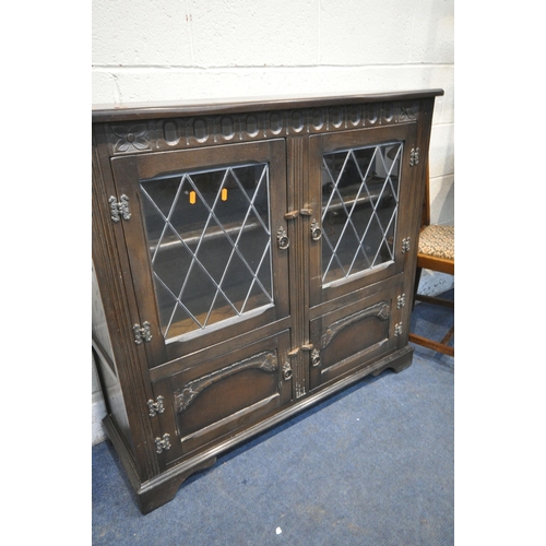 1217 - AN OAK BOOKCASE with two leaded glass cupboard doors over two smaller cupboard doors, length 109cm x... 