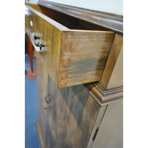 1236 - A 20TH CENTURY WALNUT TALLBOY, fitted with a single drawer above two cupboard doors, that are enclos... 