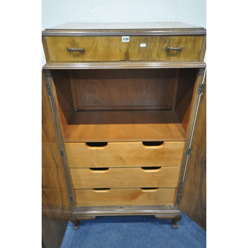 1236 - A 20TH CENTURY WALNUT TALLBOY, fitted with a single drawer above two cupboard doors, that are enclos... 