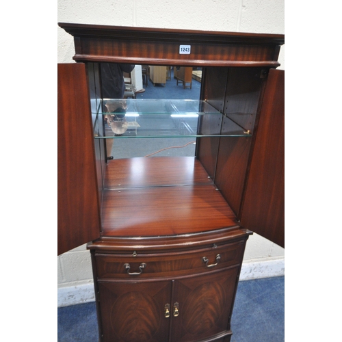 1243 - A 20TH CENTURY MAHOGANY STRONGBOW FURNITURE BOW FRONT COCKTAIL CABINET, fitted with four cupboard do... 