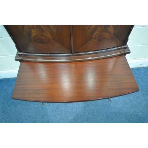 1243 - A 20TH CENTURY MAHOGANY STRONGBOW FURNITURE BOW FRONT COCKTAIL CABINET, fitted with four cupboard do... 