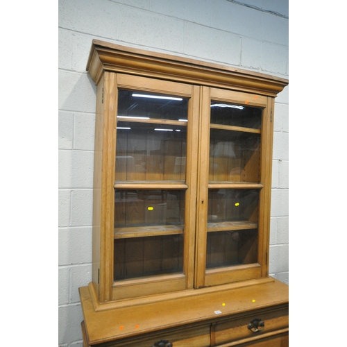 1273 - AN EARLY TO MID 20TH CENTURY OAK BOOKCASE, the top fitted with double glazed doors, that are enclosi... 