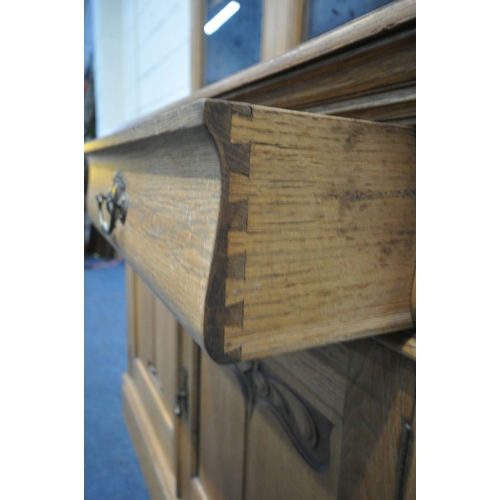 1273 - AN EARLY TO MID 20TH CENTURY OAK BOOKCASE, the top fitted with double glazed doors, that are enclosi... 