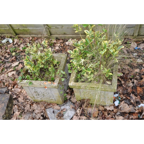 1011 - A PAIR OF MODERN COMPOSITE SQUARE GARDEN PLANTERS with Celtic panels to each face, 31cm cubed