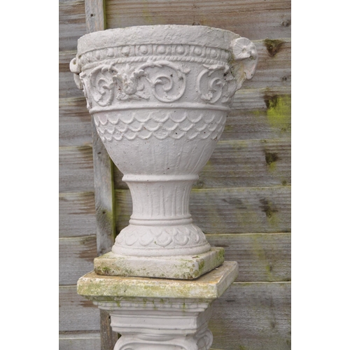 1013 - TWO MODERN COMPOSITE GARDEN URNS the smaller being 36cm high standing on a column total height 119cm... 