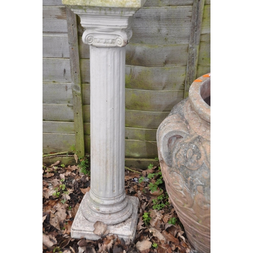 1013 - TWO MODERN COMPOSITE GARDEN URNS the smaller being 36cm high standing on a column total height 119cm... 