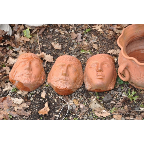 1014 - THREE MODERN TERRACOTTA FACE MASK WALL MOUNTED PLANTERS AND TWO PLANTERS the masks are 19cm high(5)