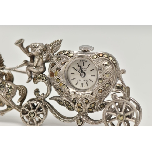 23 - A WHITE METAL WATCH BROOCH, designed as a carriage with a cherub and two horses, set with marcasite,... 