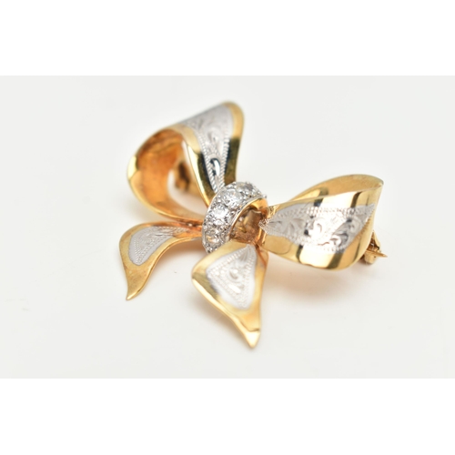 35 - A BI COLOUR DIAMOND BROOCH, designed as a yellow metal bow with white metal and engraved detail, set... 