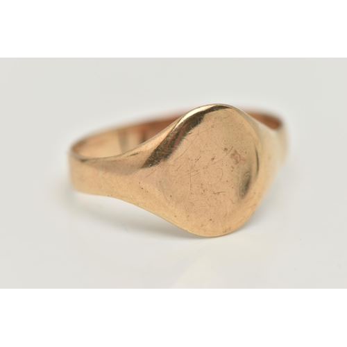 51 - A YELLOW METAL SIGNET RING, of an oval polished form, misshapen shank, approximate gross weight 3.9 ... 