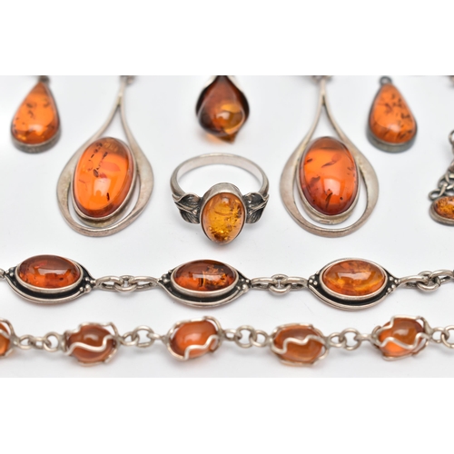 64 - A SELECTION OF AMBER SET JEWELLERY, to include two white metal bracelets set with amber cabochons, f... 