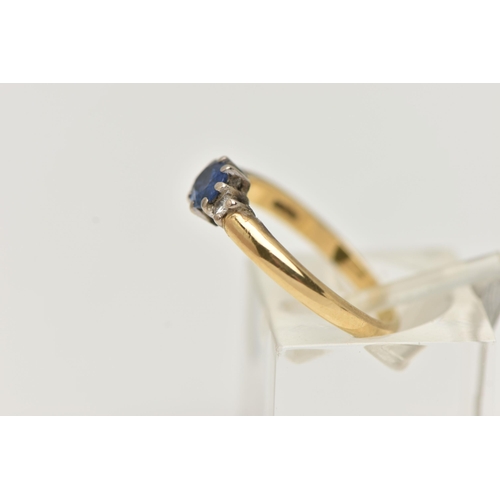 8 - AN 18CT GOLD SAPPHIRE AND DIAMOND THREE STONE RING, centring on an oval cut blue sapphire, claw set ... 