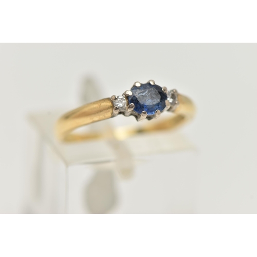 8 - AN 18CT GOLD SAPPHIRE AND DIAMOND THREE STONE RING, centring on an oval cut blue sapphire, claw set ... 