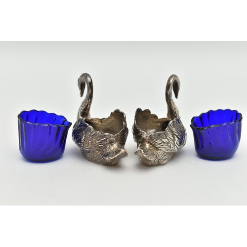 100 - A PAIR OF GEORGE V SILVER NOVELTY SALTS, matching swans with feather detail, with blue glass inserts... 