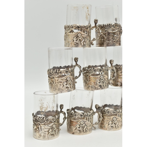 101 - A LATE VICTORIAN SET OF TWELVE LIQUEUR GLASSES, embossed putti scene and acanthus detail, with scrol... 